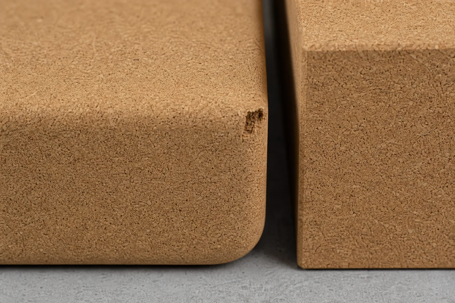 Macro photograph comparing intact cork surfaces, rounded edges and a small superficial corner chip