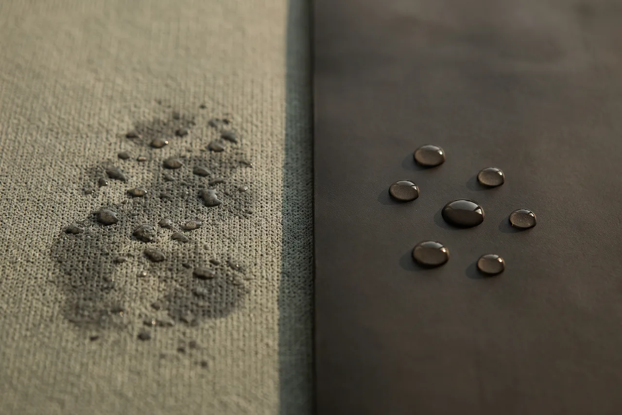 Close-up of two mat surfaces: droplets soaking into a porous textured surface, and droplets beading on a smooth closed one