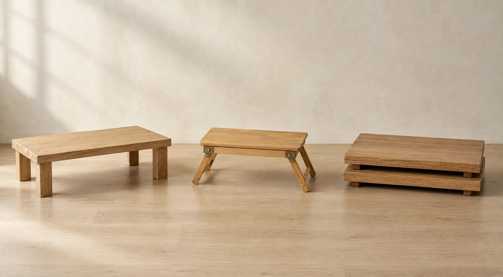 Three unbranded low wooden furniture formats: a fixed four-leg table, a folding table and two stackable platforms