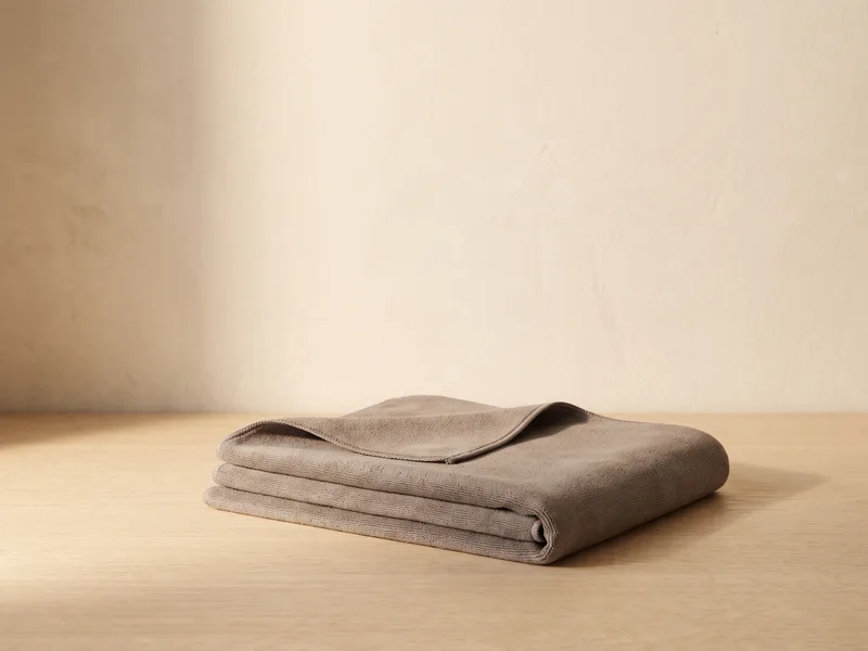 A plain folded microfibre yoga mat towel